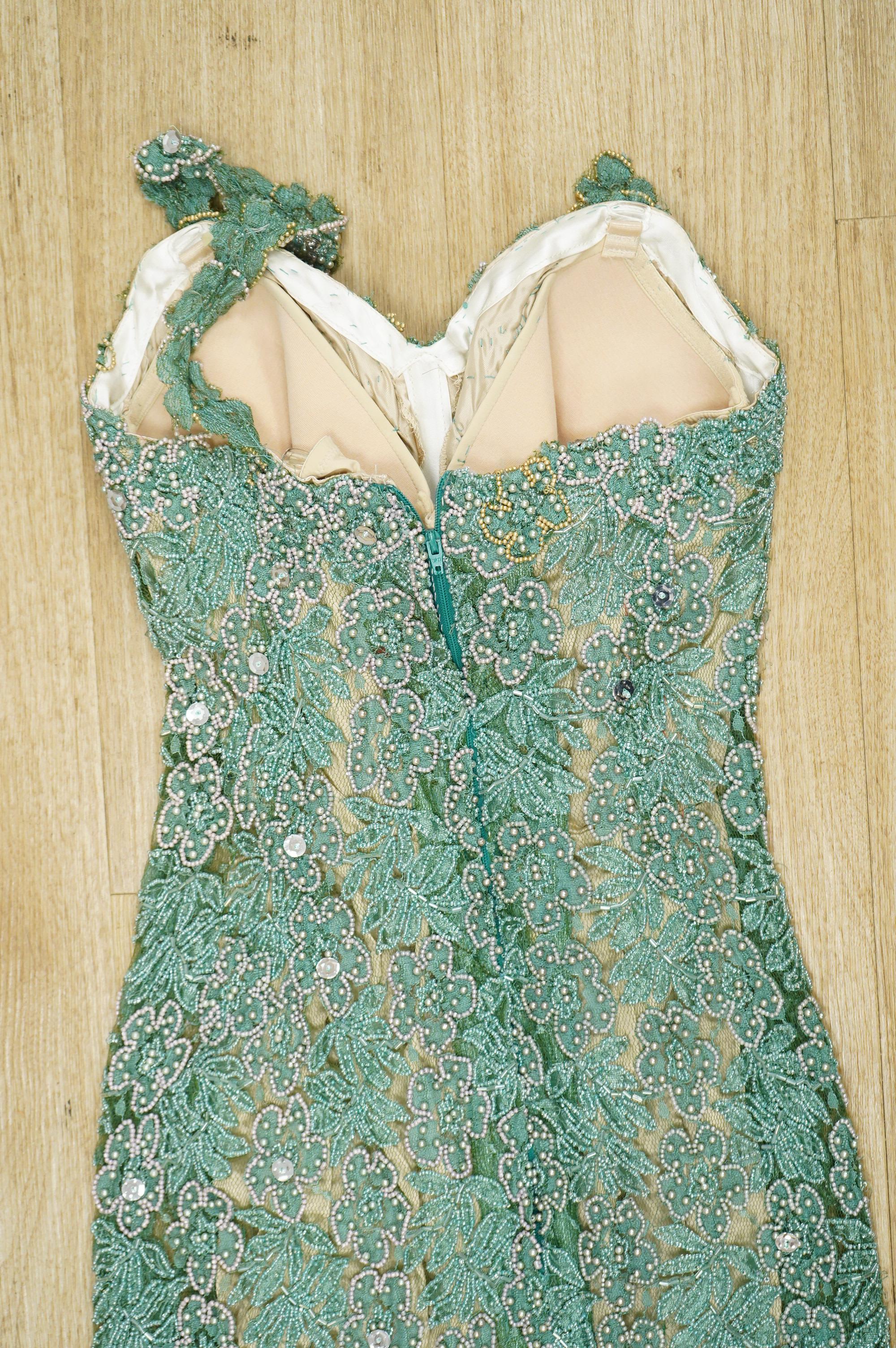 A 1960’s-70’s light green beaded and sequin floral net, fitted full length evening dress. 134cm long